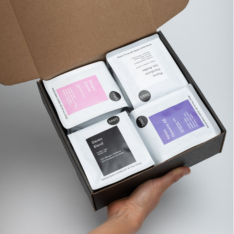 box with 4 different 8oz size coffees. showing the sample box. offerings subject to change at any time. 